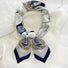 Front view of a tied satin scarf in navy, elegant accessory styling for handbags.