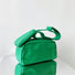 Folded view of Nylon Brick Cassette Crossbody Bag in green, easy for commuting and weekends.