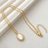 Flat lay of Ocean Breeze Necklace with Gold Jade, great for everyday outfits.