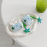 Angled view of two Oceanic Star Charm Airpods Case Cover, easy to carry for commutes and errands.