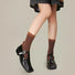 Model wearing a pair of Old Memory Socks in brown, great for casual wear and light workouts.