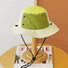 Top view of the olive green brimmed hat showing the adjustable toggle and cord.