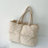 Front view of the apricot padded tote bag showcasing its square quilted texture.