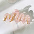 Close-up of Painted Wave Hair Claw in pink, easy for workdays and special occasions.