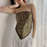 Model styling olive green paisley silk scarf as chic bandeau top showcasing versatile fashion-forward look for urban city walks.