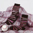Front view of pink camouflage socks with dark brown cuffs and toes, displayed on a plaid blanket.