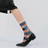 Model wearing a pair of Plaid Patchwork Socks in beige, easy to pack for travel and errands.