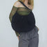 Model carrying a black nylon shoulder bag, easy for commuting and weekends.