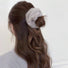 Model wearing Plush Scrunchie in gray, great for everyday styling and gifting.