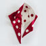Flatlay view of red and white reversible polka dot knit scarf.