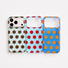 Flat lay of mint/brown dot, light blue/red dot, and blue/orange dot silicone iPhone cases displaying camera cutout alignment.
