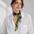 Model wearing soft green polka dot silk scarf as a neckerchief.