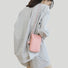 Model carrying a pink Polycolor hanging ball leather bag on the shoulder, ideal for city walks and gifting.