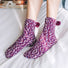 Model wearing a pari of Pompom Cupcake Socks in purple, easy to pack for travel and errands.