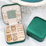 Front view of Open Emerald green velvet jewelry case with mirror, ring rolls, and compartments storage.