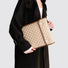 Model carrying a khaki laptop sleeves handheld, great for daily carry and travel.
