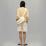 Model carrying a beige polyester bag as crossbody, ideal for city walks and gifting.