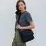Model carrying a black Puffy Knot Quilted Bag as crossbody, easy for commuting and weekends.