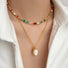 Model wearing the vibrant rainbow beaded necklace and gold jade necklace as layers style.