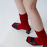 Model wearing a pair of red cotton slouch socks, great for casual wear and light workouts.