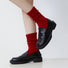 Model wearing a pair of Red cotton slouch socks with a ruched design.