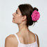 Back view of a model styling a vibrant magenta pink rose hair claw in a bun updo.