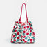 Front view of White polyester tote bag with red rose print, green leaves, and two red grab straps.