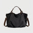 Front view of the black rugged cargo canvas tote bag with leather trim.