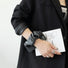 Front view of Black Satin Wristband Case. Integrated luxurious satin-textured strap for secure carry.