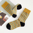 Cotton Sculptured Ripple Knitted Socks in mustard yellow with teal stripes and black toes/heels.