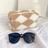 Angle view of sherpa teddy makeup bag in khaki , great for on-the-go touch-ups.