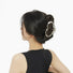 Model wearing a Silver Cloud hair claw, ideal for quick updos and ponytails.