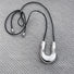 Flat lay of Silver Crescent Pendant Necklace, great for everyday outfits.