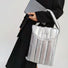 Model carrying a silver polyester bag in hand, ideal for city walks and gifting.