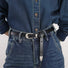 Close-up of the sleek edge belt detail styled on a denim outfit.