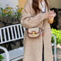 Model wearing a small retro saddle crossbody bag; versatile heritage style accessory for daily fashion.