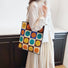 Model carrying a Smiley Plaid Knitted Bag on the shoulder , ideal for city walks and gifting.