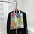 Flat lay of Smiley Plaid Knitted Bag in green, great for everyday carry and travel.
