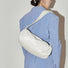 Model carrying a white Soft Leather Baguette Bag on the shoulder, ideal for city walks and gifting.