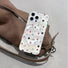 Clear acrylic case with iridescent ripple effect and scattered pink, black, and white stars.