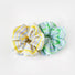 Angled view of two Stripe Scrunchies shown together, yellow and green.