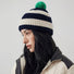 Mode wearing a navy and white striped beanie with a green pompom.