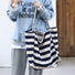 Model carrying a navy blue striped tote bag handheld, great for daily carry and travel.