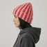 Side view of Model wearing Striped Fluffy Knit Beanie in pink, highlighting the thick, fluffy knit texture.