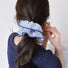 Model wearing a blue Striped Layered Scrunchie, easy for workdays and special occasions.