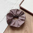 Flat lay of Striped Layered Scrunchie in brown and white, great for everyday styling and gifting.