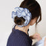 Model wearing a Striped Layered Scrunchie in blue and white, ideal for everyday outfits and office looks.