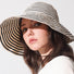 Model wearing Striped Wide Brim Bucket Hat in khaki black. Pure breathable cotton for outdoor leisure.