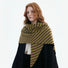 Side view of the model wearing the green striped wool triangle scarf as a shawl over her shoulder.
