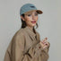 Model wearing blue Sun Day Cap. Boasts a durable curved brim and premium breathable fabric for sunny days.